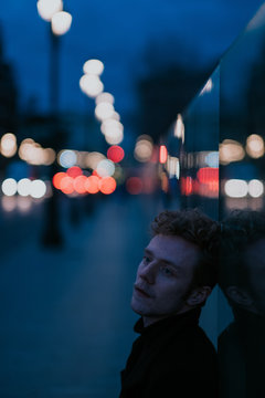 portrait of a stylish young man on the blue city