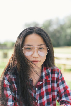 Portraits of Asian woman with glasses at park