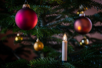 christmas tree decoration close up with burning candle