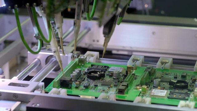 Electronic circuit board production. Automated Circut Board machine Produces Printed digital electronic board. Electronics contract manufacturing. Manufacture of electronic chips. High-tech.