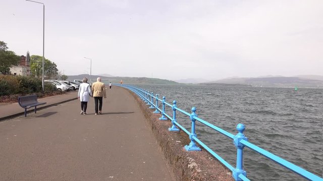 Cinemagraph on Greenock Esplanade.  Static walkers beside the turbulent waters of the River Clyde.