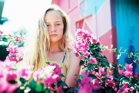 blonde teenage girl with long wavy hair with bright colors in summer