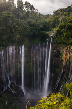 huge waterfall in green lush jungle