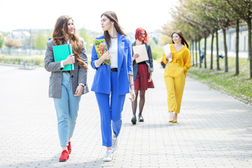 Obraz premium Beautiful girls go and communicate with each other. Concept of lifestyle, friendship, students