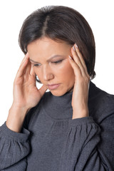 Young woman with headache on white background