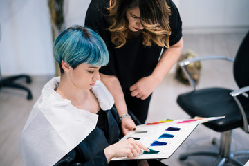 Young Woman dyeing her hair at a Salon