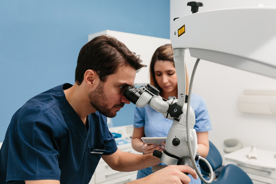 Dentists using microscope