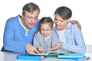 Parents with daughter reading books on white background