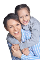 Happy mother with daughter posing on white background