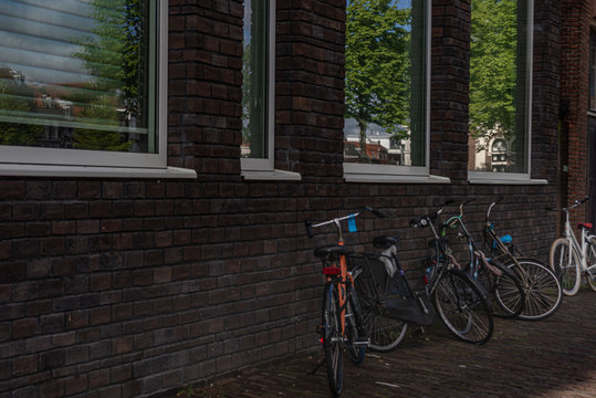 Group of bicycles parked near brick wall