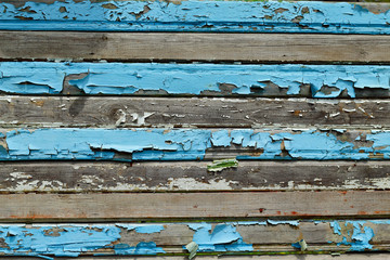 Cracked blue paint on wooden boards
