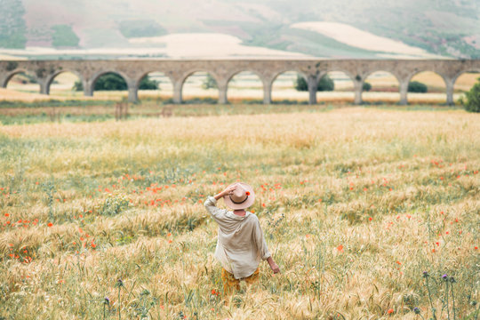 Young girl enjoining summer in a field