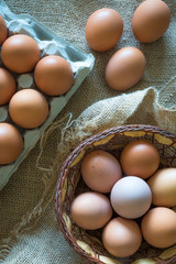 eggs placed  in a egg carton and  а wicker basket over a tat