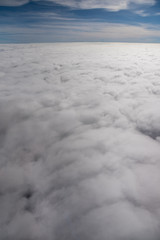 Aerial View from an Airplane. Flying above Clouds at Sunrise