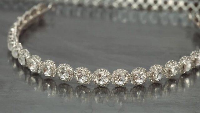 Close up of wreath of pearls spinning with metallic background