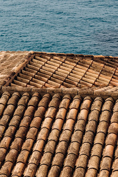 Abstract view of tile roof and sea