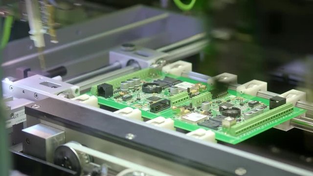 Electronic circuit board production. Automated Circut Board machine Produces Printed digital electronic board. Electronics contract manufacturing. Manufacture of electronic chips. High-tech.