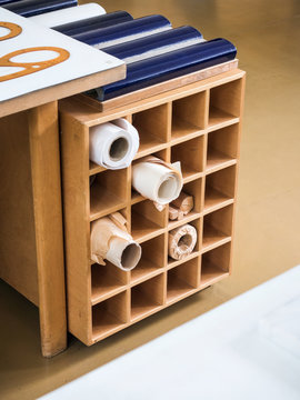 Square wooden rack with rolled paper