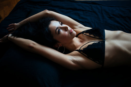 Woman In A Bra Lying In Bed Stock Photo, Picture and Royalty Free Image.  Image 94448399.
