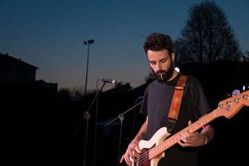 bass player tuning his instrument