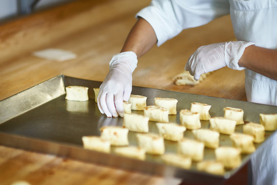 The making of cinnamon rolls in a bakery