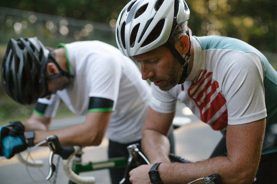 Cyclists resting after riding bicycles