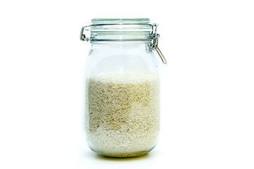 The rice stored inside the closable glass bottle isolated on a white background. 