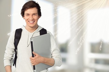 Male student with laptop on background