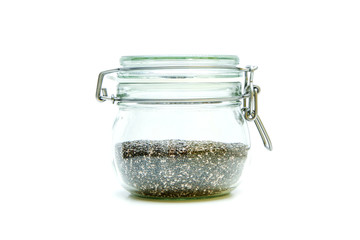 The chia seeds stored inside the closable glass bottle isolated on a white background. 