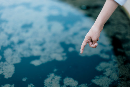 Young boy points to beautiful, Bay Area pond at dusk