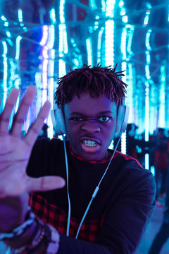 Expressive black man in neon lights