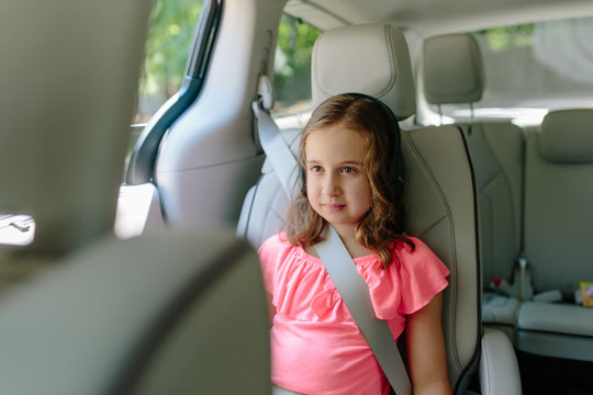 Cute young girl watching entertainment in a car