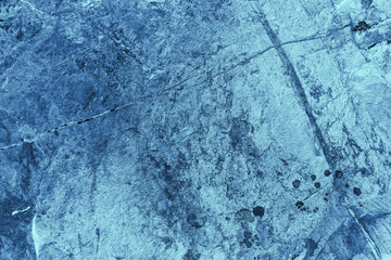 Vintage blue background. Rough painted wall of sapphire color. Imperfect plane of blue colored. Uneven old decorative toned backdrop of cyan tint. Texture of sapphirine hue. Ornamental stony surface.