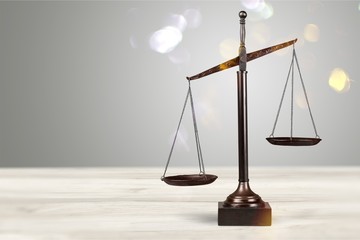 Law scales on table background. Symbol of