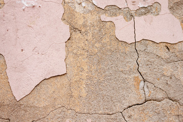 Background rough rustic shabby texture of old wall with pink cracked plaster and cement