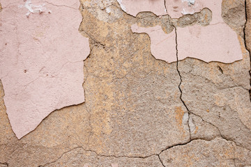 Background rough rustic shabby texture of old wall with pink cracked plaster and cement