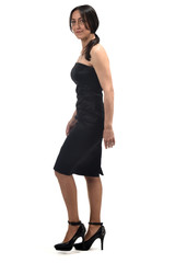 full portrait of a middle age woman walking with off the shoulder dress and heeled shoes isolated on white