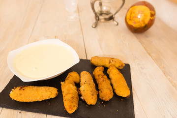 Cheese and ham croquettes with garlic sauce