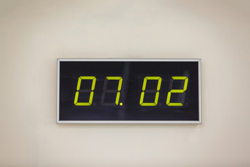 Black digital clock on a white background showing time 07.02 minutes