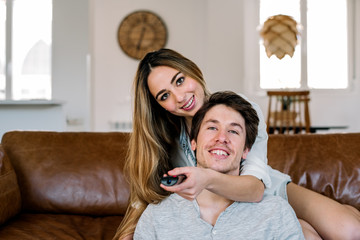 Happy couple watching tv