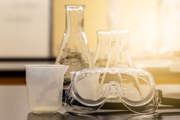 Collection of scientific equipment organized upon a counter within a brightly lit lab