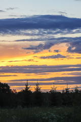 Beautiful cloudscape with blue sky and bright clouds at sunset in summer.