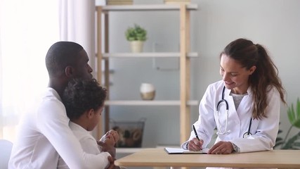 Female caucasian doctor listening to african father of little patient - Powered by Adobe