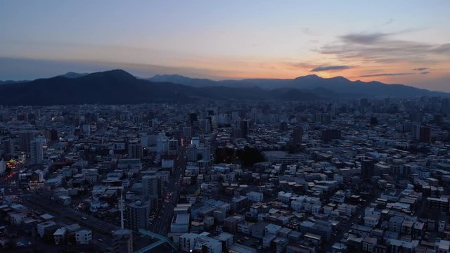 Flying over Sapporo during twilight hour - Hokkaidō, Japan - Aerial shot