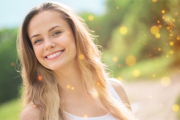 Young woman on field under sunset light