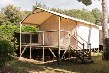 elevated canvas safari tent in camping park
