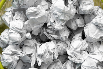 Closeup of metal bin with crumpled paper, top view