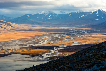 Hiking along the mountains - View over adventdalen fjord from above - the most Northern settlement in the world. Svalbard, Norway