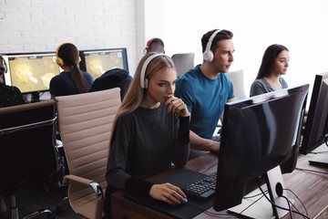 Young people playing video games on computers indoors. Esports tournament © New Africa