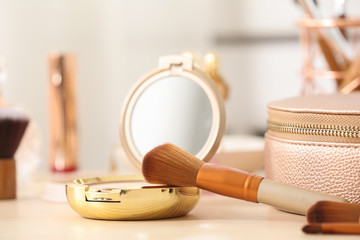 Pocket powder with brush on dressing table, closeup